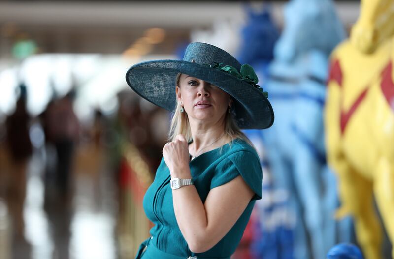A guest matches her teal hat to her dress. Pawan Singh / The National