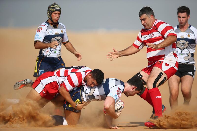 RAS AL KHAIMAH, UNITED ARAB EMIRATES - OCTOBER 21:  Alan Monkhouse of Beaver Nomads is tackled by Tristan Noel of RAK Goats  during the Community League match between RAK Goats and Beaver Nomads at Bin Majid Beach Resort on October 21, 2016 in Ras Al Khaimah, United Arab Emirates.  (Photo by Francois Nel/Getty Images)
