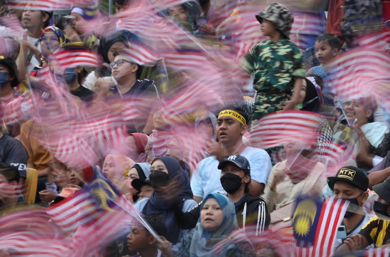Malaysians wave their country's flag during the National Day 2022 celebrations, in Kuala Lumpur. Reuters