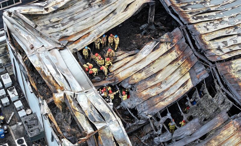Investigators at the scene of a fire at a lithium battery plant in Hwaseong, South Korea, which killed at least 22 people, including 20 foreign nationals.  EPA