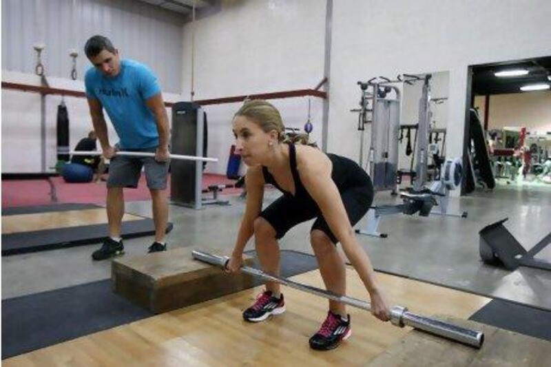 Ikaika Paakaula and Melanie Swan during Olympic lifting training at a gym in Al Quoz in Dubai. Pawan Singh / The National