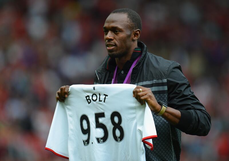 MANCHESTER, ENGLAND - AUGUST 25:  Jamaican Athlete Usain Bolt poses with a United shirt prior to the Barclays Premier League match between Manchester United and Fulham at Old Trafford on August 25, 2012 in Manchester, England.  (Photo by Shaun Botterill/Getty Images)