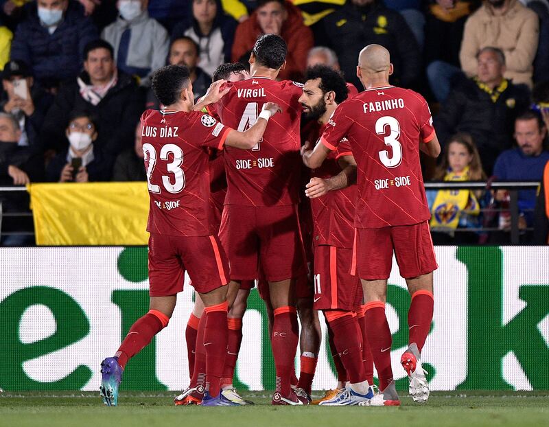 Liverpool's Sadio Mane celebrates scoring their third goal with teammates. Reuters