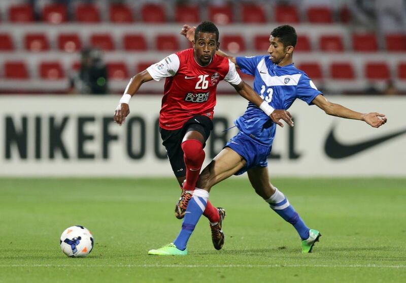 Abdelaziz Haikal, left, avoids getting tackled, but his Al Ahli side were forced to a goalless draw at home to Al Hilal, from Saudi Arabia. Al Ittihad