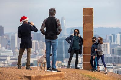 A gingerbread monolith stands on Christmas Day, Dec. 25, 2020, on a bluff in Corona Heights Park overlooking San Francisco. A nearly 7-foot-tall monolith made of gingerbread mysteriously appeared on the San Francisco hilltop on Christmas Day and collapsed the next day. The three-sided tower, held together by icing and decorated with a few gumdrops, delighted the city when word spread about its existence. (Karl Mondon/Bay Area News Group via AP)