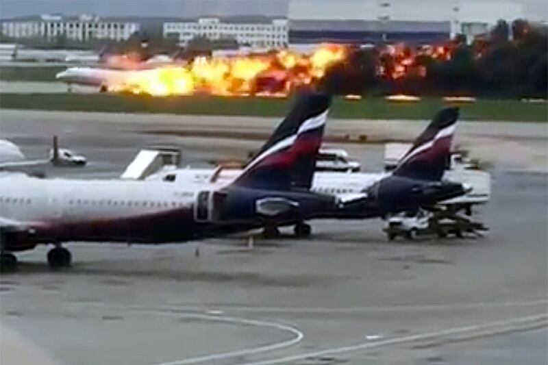The SSJ-100 aircraft of Aeroflot Airlines on fire during an emergency landing. @artempetrovich via AP