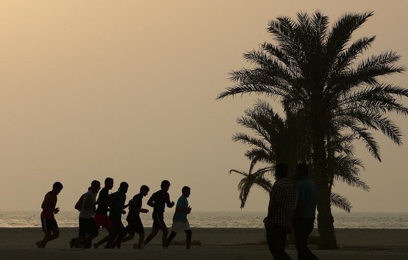 SHARJAH, UNITED ARAB EMIRATES Ð July 26: Some of the Emirati guys jogging at the beach during the evening time near the Coral beach hotel in Sharjah. People start coming to beach side during the evening and spend time with family and friends. During fridays it is very difficult to find the parking space for the car. (Pawan Singh / The National) For News. A Week In Feature
