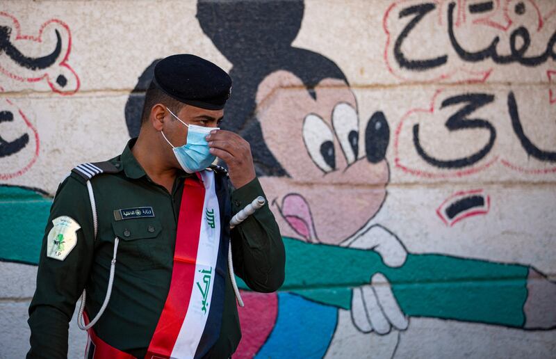 A member of the Iraqi security forces stands guard outside a polling station in the southern city of Basra. Photo: AFP
