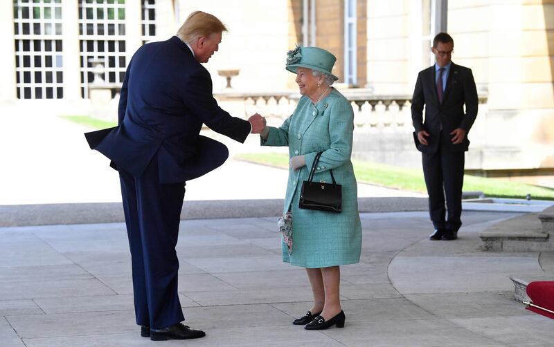 Britain's Queen Elizabeth II (C) shakes hands with US President Donald Trump during a welcome ceremony at Buckingham Palace in central London on June 3, 2019, on the first day of the US president and First Lady's three-day State Visit to the UK. Britain rolled out the red carpet for US President Donald Trump on June 3 as he arrived in Britain for a state visit already overshadowed by his outspoken remarks on Brexit. / AFP / POOL / Victoria Jones
