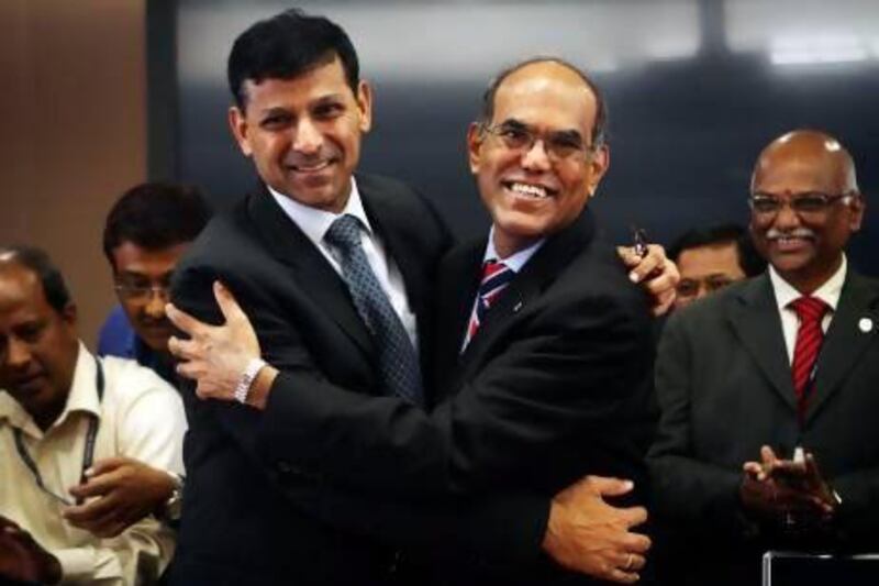 Raghuram Rajan (left), newly appointed governor of Reserve Bank of India, hugs the outgoing governor Duvvuri Subbarao during a taking over ceremony at the bank's Mumbai headquarters.