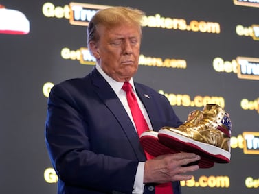 Former president Donald Trump with his gold trainers at Sneaker Con Philadelphia. AP