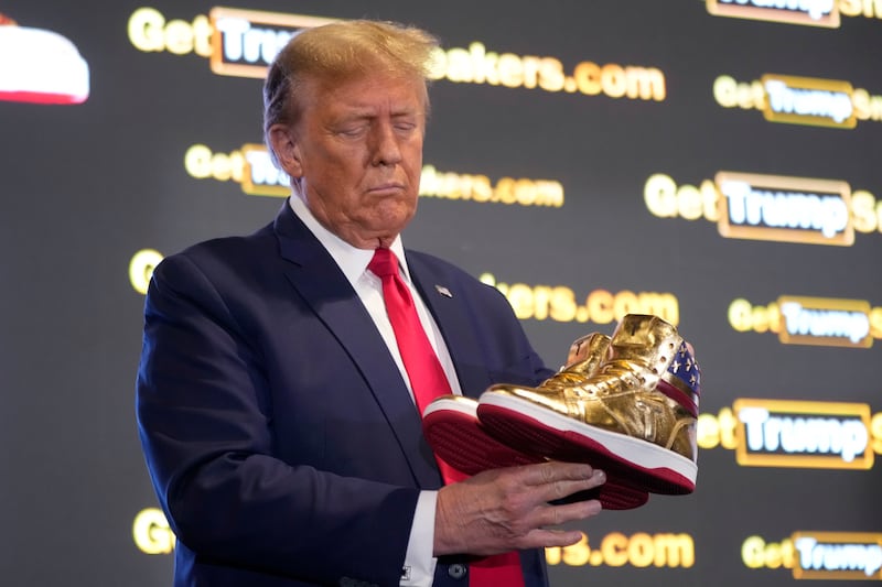 Former president Donald Trump with his gold trainers at Sneaker Con Philadelphia. AP