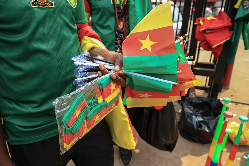 Theodore, 28, a vendor, holds football accessories in Yaounde - the capital of Cameroon that will host the Africa Cup of Nations from January 9, 2022. AFP