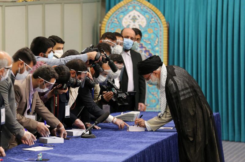 Iran's supreme leader Ayatollah Ali Khamenei is greeted by electoral workers as he arrives to cast his ballot in the Islamic republic's presidential election. AFP