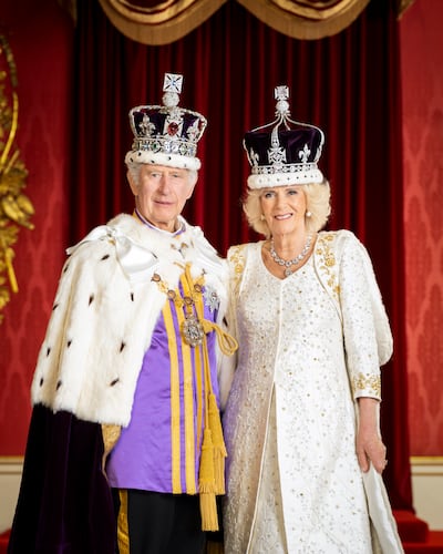 King Charles III and Queen Camilla in the Throne Room at Buckingham Palace, London. PA