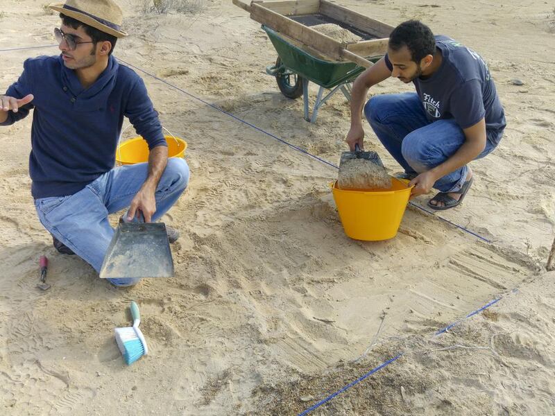 From left: Abdul Al Kaabi, an archaeologist from Abu Dhabi Tourism and Culture Authority (TCA) and Fadhl Al Eryani, an NYUAD student, carry out excavations at Saadiyat site B. TCA, NYUAD and Zayed University are working together on the Saadiyat Coastal Heritage Project. Courtesy Dr Robert Parthesius