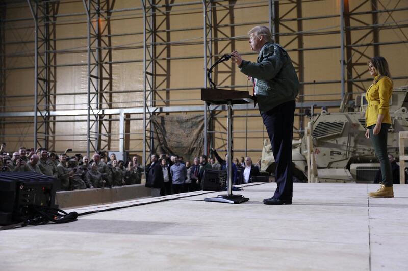 US President Donald Trump, with first lady Melania Trump, delivers remarks to US troops in an unannounced visit to Al Asad Air Base, Iraq. Reuters