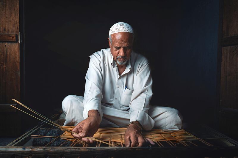 Mujtaba Al Awami, Saudi Arabia: Mujtaba captures an old man fashioning traditional household items, including baskets, chairs, and small tables, using threads of palm trees in the Ahsa’ province in eastern Saudi Arabia.