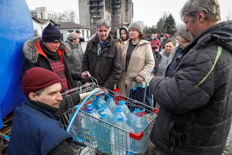 The conflict has forced Mariupol residents to wait in line for drinking water. Reuters