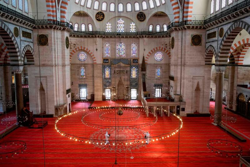 Fatih municipality workers disinfect the Suleymaniye Mosque before its reopening on the last day of the Eid Al Fitr in Istanbul. AFP