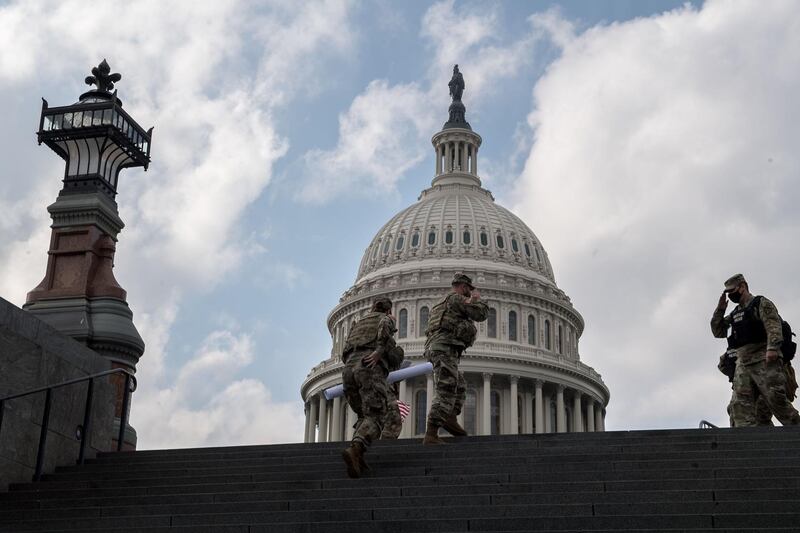 WASHINGTON, DC - JANUARY 15: Soldiers salute one another at the US Capitol ahead of the inauguration on January 15, 2021 in Washington, DC. After last week's Capitol Riot security has increased around the Capitol and the FBI has warned of additional threats against the US Capitol and in all 50 states.   Liz Lynch/Getty Images/AFP
== FOR NEWSPAPERS, INTERNET, TELCOS & TELEVISION USE ONLY ==
