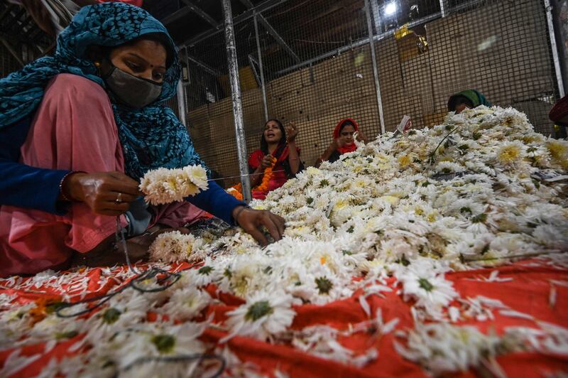 A woman makes garlands in New Delhi. AFP