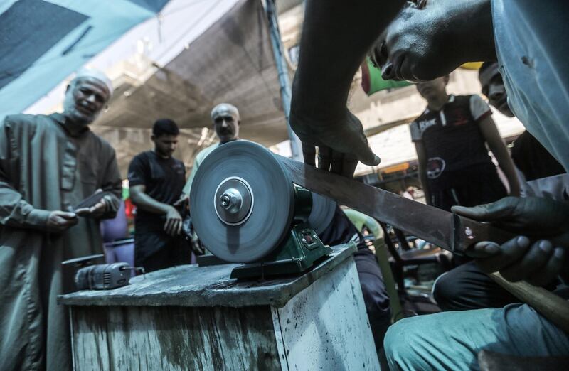 Palestinian blacksmiths sharpen various tools and knives to be used to sacrifice animals in Gaza City. EPA