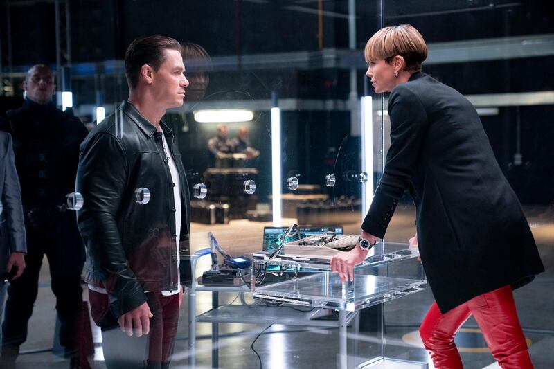 This image released by Universal Pictures shows John Cena, left, and Charlize Theron in a scene from "F9." (Giles Keyte/Universal Pictures via AP)
