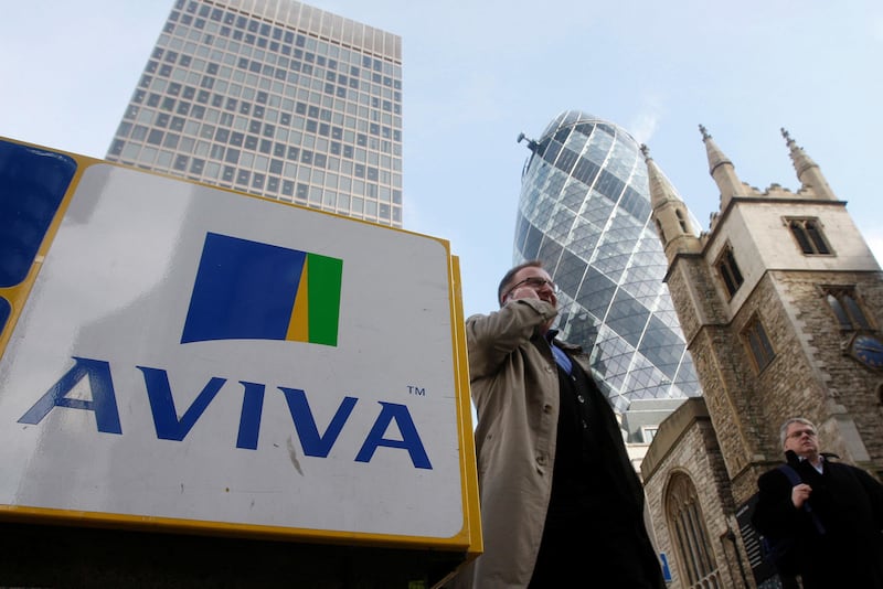 FILE PHOTO: Pedestrians walk past an Aviva logo outside the company's head office in the city of London, Britain March 5, 2009.  REUTERS/Stephen Hird/File Photo