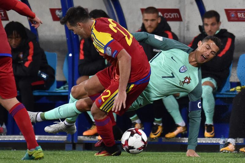 Cristiano Ronaldo is fouled by Andorra'midfielder Victor Rodriguez Pascal Pavani / AFP