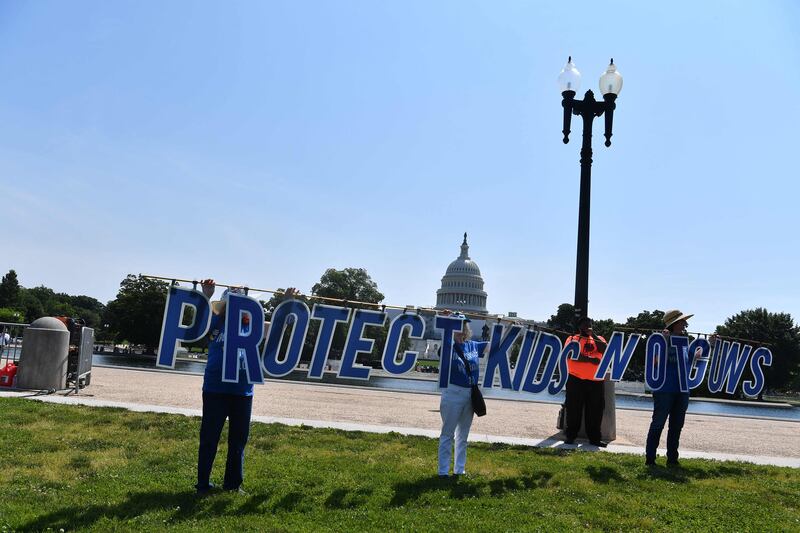 Activists hold up a sign outside the US Capitol. AP