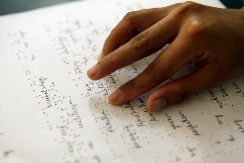 A student reads with his hands from Braille notes downloaded from the Bookshare library. The world’s largest online library of accessible books is now in the UAE aiming to get private and government companies, schools and colleges on board to  turn manuals, journals, material into accessible content for the visually impaired. Courtesy Benetech