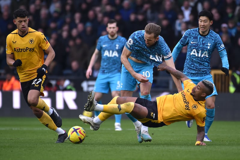 Wolves' Mario Lemina challenges Tottenham striker Harry Kane. AP