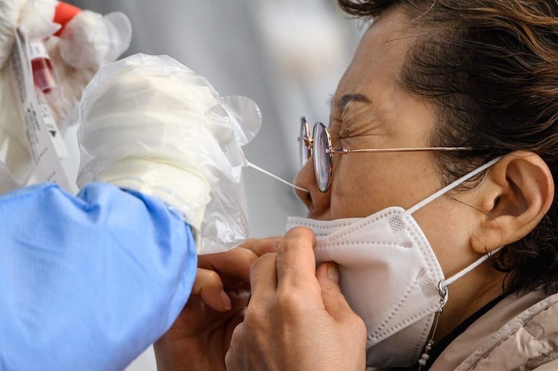 A woman undergoes a PCR test at a Covid-19 testing centre in Seoul, South Korea. AFP