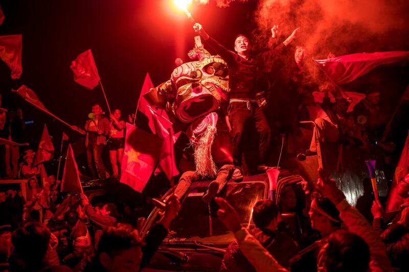 Football fans celebrate in front of My Dinh Stadium as Vietnam win the first ASEAN Football Federation Suzuki Cup in Hanoi, Vietnam. Getty Images