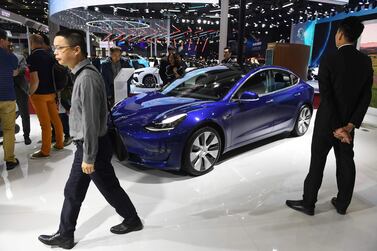 Visitors walk past a Tesla Model 3 at the Shanghai Auto Show in Shanghai on April 17, 2019. Tesla is investigating whether its Model S exploded while parked on a street in the Chinese city. AFP