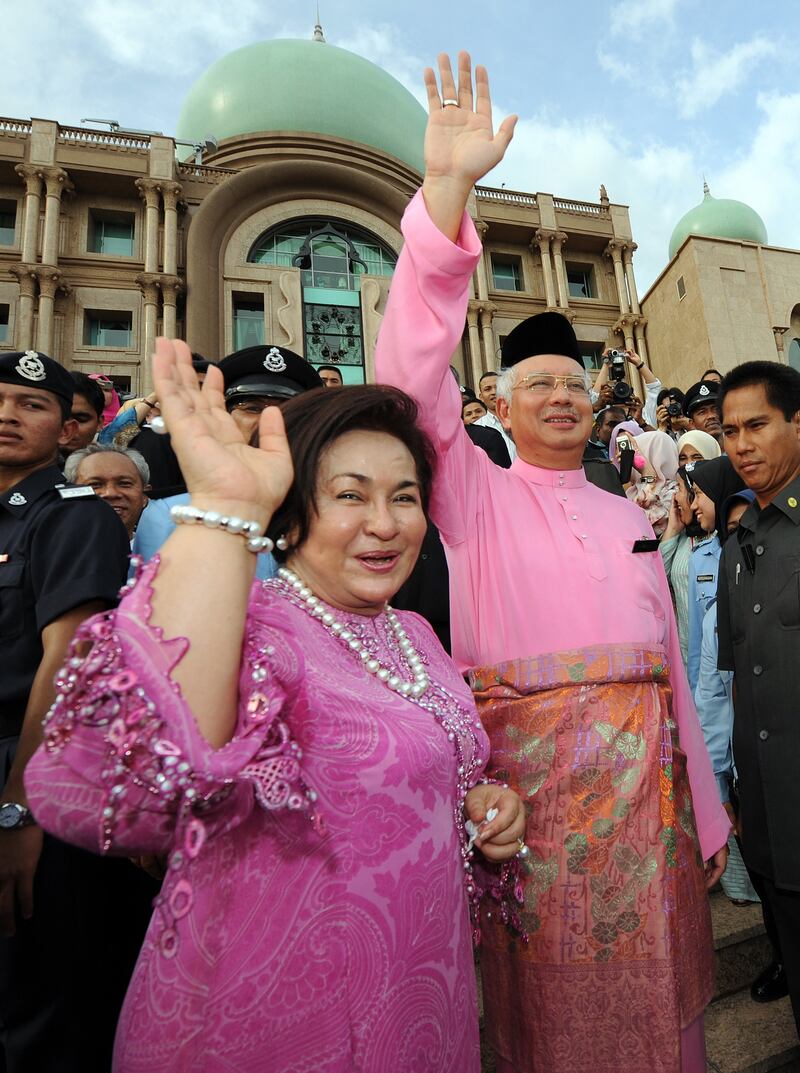 Najib Razak and his wife waving to supporters as they enter the prime minister's office, after seeing off the former premier Abdullah Ahmad Badawi. AFP
