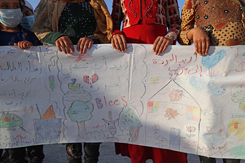 Syrian children display the banner they produced for World Peace Day.