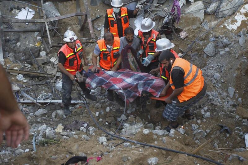 Rescue workers carry the body after removing it from under the rubble of a home following an Israeli air strike on Khan Yunis in the southern of Gaza strip. Israel insists it “does not target” civilians and civilian sites, even if history tells us otherwise. Said Khatib / AFP

