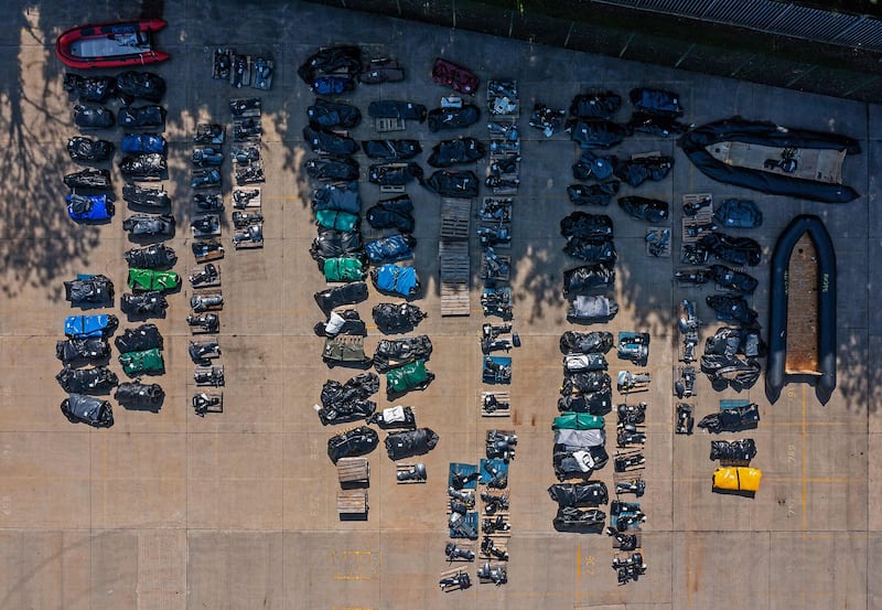 An aerial view shows rolled-up inflatable dinghies and outboard engines, stored in a Port Authority yard in Dover. AFP