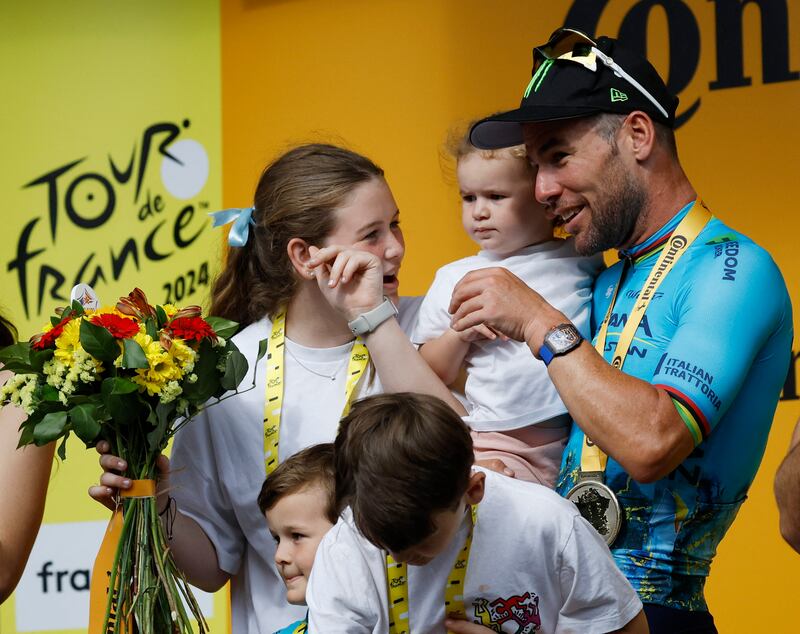 Astana Qazaqstan Team's Mark Cavendish celebrates on the podium with his children after his 35th stage win victory. Reuters