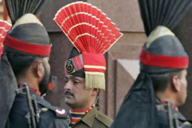 Pakistani Rangers and Indian Border Security Force personnel, center, take part in the daily flag lowering ceremony at the India-Pakistan joint border at Wagah. Indian security officials believe the ceasefire was successful primarily because of Mr Musharraf.