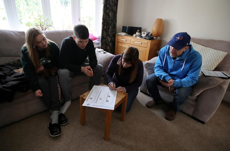 A family prepare for the take Virtual Grand National. Reuters