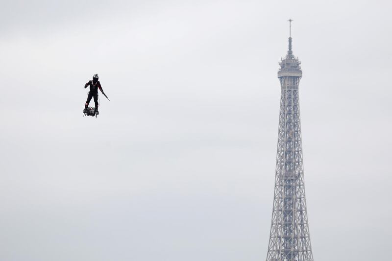Franky Zapata takes to the air during the traditional Bastille Day military parade on the Champs-Elysees Avenue with the Eiffel Tower in the background in Paris, France. Reuters