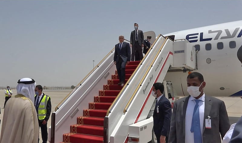 Emirati officials welcome Israeli Foreign Minister Yair Lapid upon his arrival at Abu Dhabi airport on Tuesday. Mr Lapid was making the first official trip by an Israeli minister to the UAE after the two countries normalised ties last year. AFP