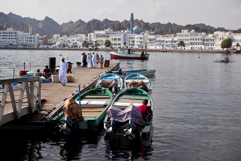 Backed by the white buildings that line the corniche of Mutrah district, fishermen and delivery staff work near the Mina Sultan Qaboos in downtown Muscat, the capital of the Sultanate of Oman on Wednesday, Oct. 12, 2011. (Silvia Razgova / The National)

