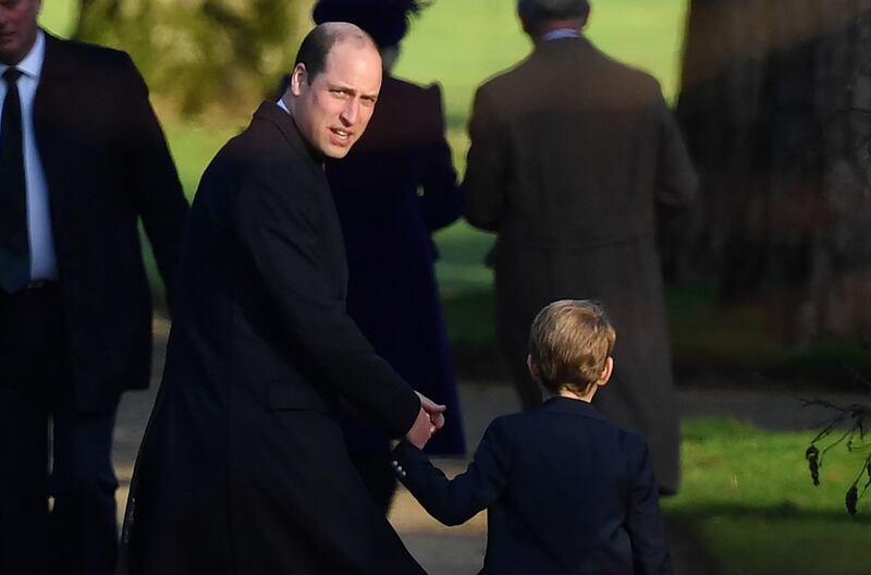 Britain's Prince William, Duke of Cambridge, left, and Britain's Prince George of Cambridge leave after the Royal Family's traditional Christmas Day service at St Mary Magdalene Church. AFP