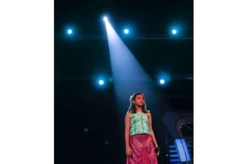 Rima Chakravorty, 14, waits for her cue before the start of her performance during the taping of the musical reality show Sa Re Ga Ma Pa Lil Champs inside a studio in Mumbai. Danish Siddiqui / Reuters