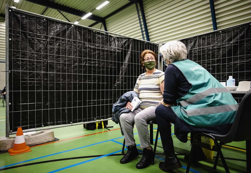 A healthcare worker administers a vaccine in Ameland, the Netherlands. The vaccination of the elderly and care workers has started on the Frisian Wadden Islands. EPA