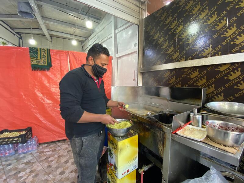 Ahmad Tumeh, an Egyptian shop owner, prepares falafel at his stall in Raghadan Market. Amy McConaghy / The National